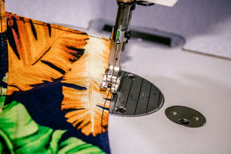 sewing machine making or sewing clothes in an industrial sewing workshopの写真素材
