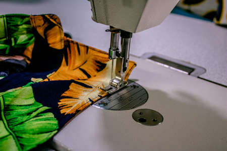 sewing machine making or sewing clothes in an industrial sewing workshopの写真素材