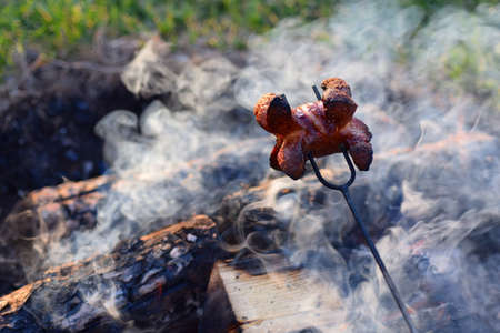 Baking sausages is a traditional village style of barbecue in the Czech Republic. Well done pork...