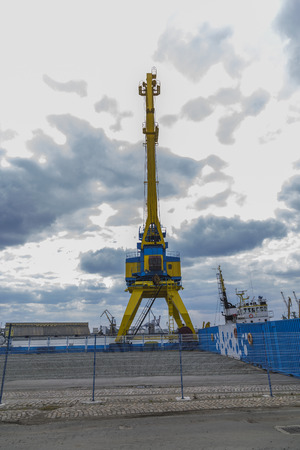 A high port crane in blue and yellow against the background of a dramatic skyの写真素材