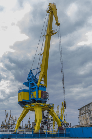 A high port crane in blue and yellow against the background of a dramatic skyの写真素材