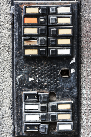 old intercom system. broken, broken, dirty and scary bells. press and ring. used bells in locked homes of the last century.の写真素材