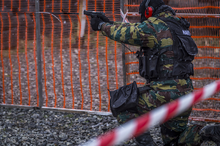 soldiers train shooting with a gun. a group of soldiers are practicing in cold snowy weather....