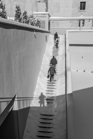 the photographer takes a picture of the stairs in snowy weather. urban landscape or street photography in winter.の写真素材