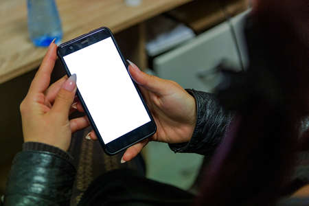 girl holds a smartphone and shoots photo and video and shares online with her friends. modern...