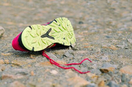 Lost Running Shoe. Running shoe on rough sourface. Running concept.の写真素材