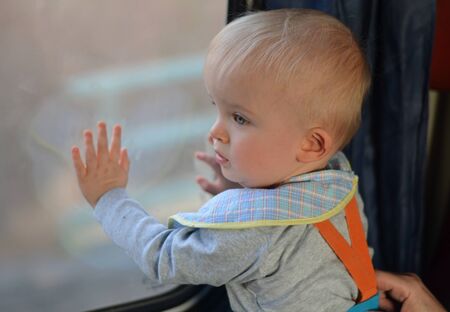 Little boy looking from train window. Child conceptの写真素材