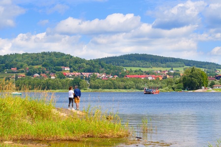 LIPNO, CZECH REPUBLIC - JULY 20, 2017: Romantic view of Lipno and tourists waiting on the shore for arriving ferry in BliÅ¾Å¡Ã­ Lhota. Lipno lake.のeditorial素材
