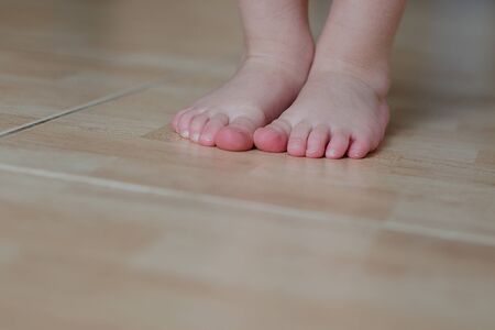 Baby bare foot on  floorの写真素材