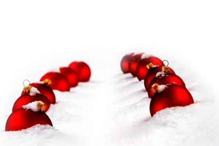 Christmas  and red glass ball on fresh white snowの写真素材