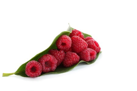 Berries ripe, red raspberry with green leaf isolated on white の写真素材