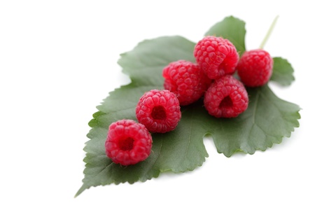 Berries ripe, red raspberry with green leaf isolated on white の写真素材