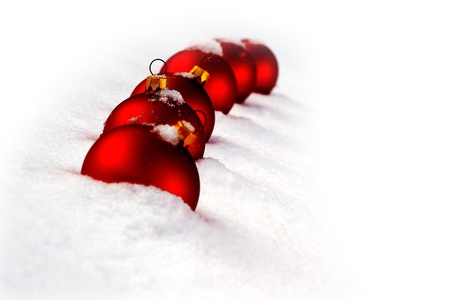 Christmas  and red glass ball on fresh white snowの写真素材