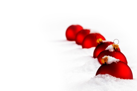 Christmas  and red glass ball on fresh white snowの写真素材