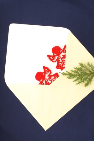 Christmas greetings with envelope and pair red angelsの写真素材