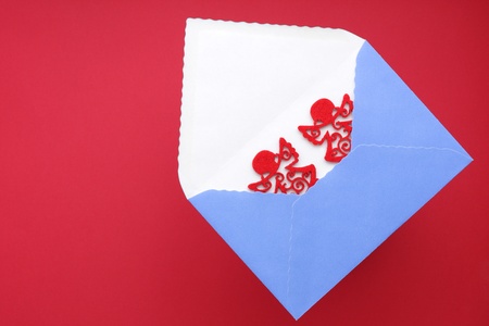 Christmas greetings with envelope and pair red angelsの写真素材