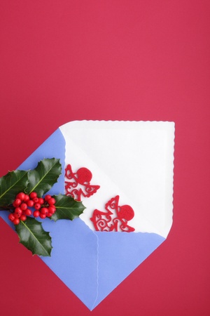 Christmas greetings with envelope and pair red angelsの写真素材