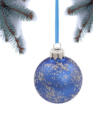 Christmas evergreen spruce tree and glass ball on snow backgroundの写真素材