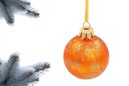 Christmas evergreen spruce tree and glass ball on snow backgroundの写真素材