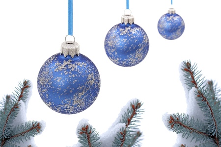 Christmas evergreen spruce tree and glass ball on snow backgroundの写真素材