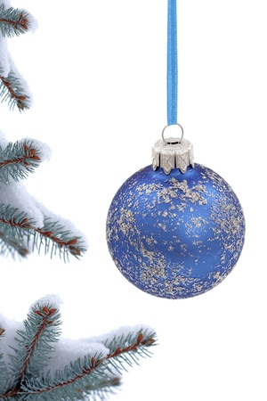 Christmas evergreen spruce tree and glass ball on snow backgroundの写真素材