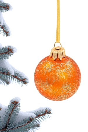 Christmas evergreen spruce tree and glass ball on snow backgroundの写真素材