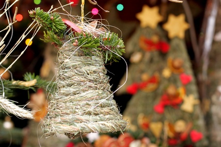Folk christmas  bell  made of grass  with ornaments, holidays backgroundの写真素材