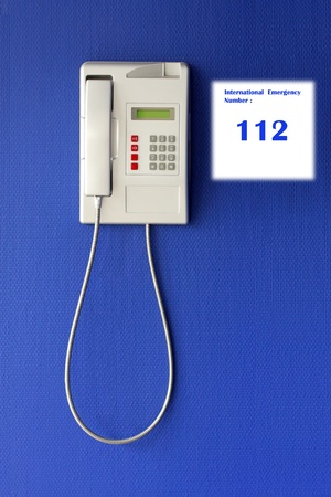 Wall phone on blue background, phone conceptの写真素材