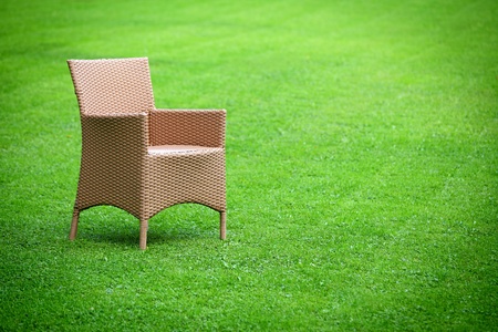 Empty chair in the middle of the lawnの写真素材