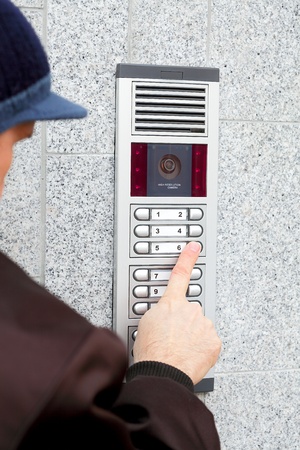 Video intercom in the entry of a house and stranger guest, technology and security backgroundの写真素材