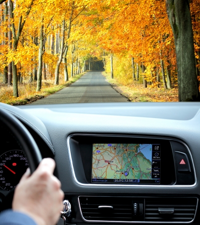 Travel by car with gps in autumnal sceneryの写真素材