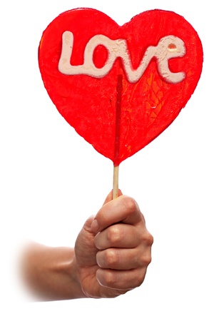 Woman hand with  red sweet valentine lollipopの写真素材