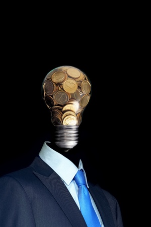 Elegant  businessman with head made by glass bulb full of coinの写真素材
