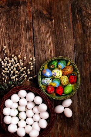 Easter eggs and  natural wooden country table, background and textureの写真素材