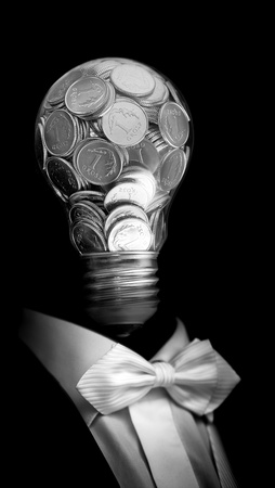 Elegant  businessman with head made by glass bulb full of silver coinの写真素材
