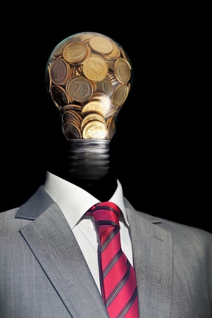 Elegant  businessman with head made by glass bulb full of coinの写真素材