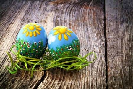 Easter eggs and  natural wooden country table, background and textureの写真素材