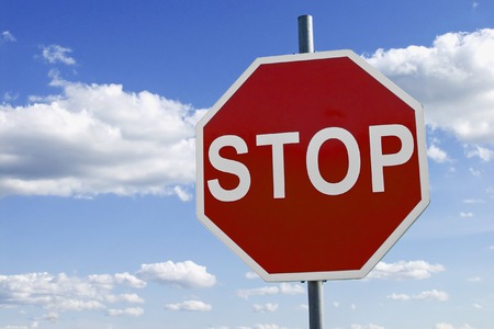 stop sign against cloudy blue skyの写真素材