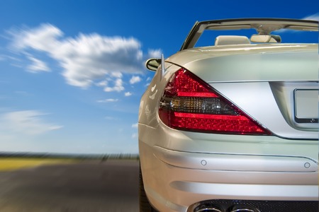 Silver sportscar driving fast