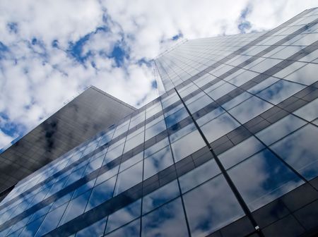 Skyscraper reflecting cloudy skyの写真素材