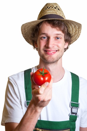 Young Farmer showing his fresh tomatoの写真素材