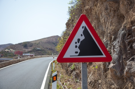 Road sign warning of falling rocks in Spainの写真素材