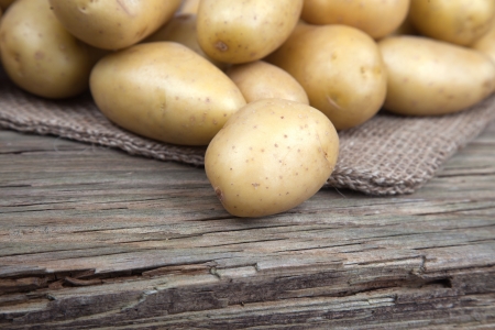 Locally grown potatoes on old woodの写真素材