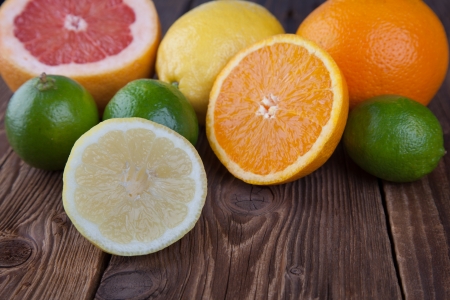 Half citrus and half orange on woodの写真素材