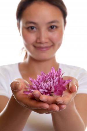 Smiling asian girl with a flower の写真素材