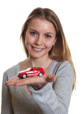 Young woman presenting her first carの写真素材