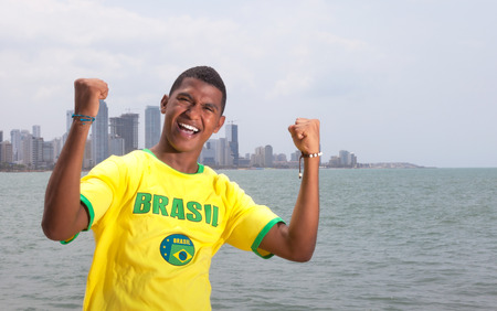 Happy brazilian guy at beach の写真素材