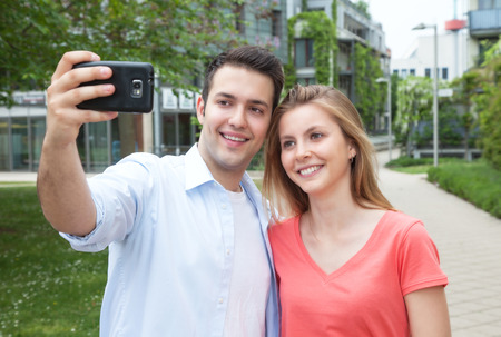 Young couple taking a selfie with mobile phone