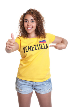 Young woman from Venezuela pointing at shirtの写真素材