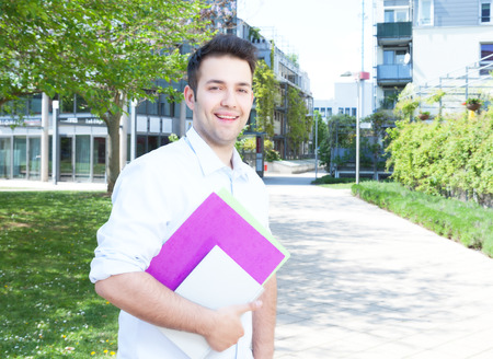 Laughing student walking on campusの写真素材